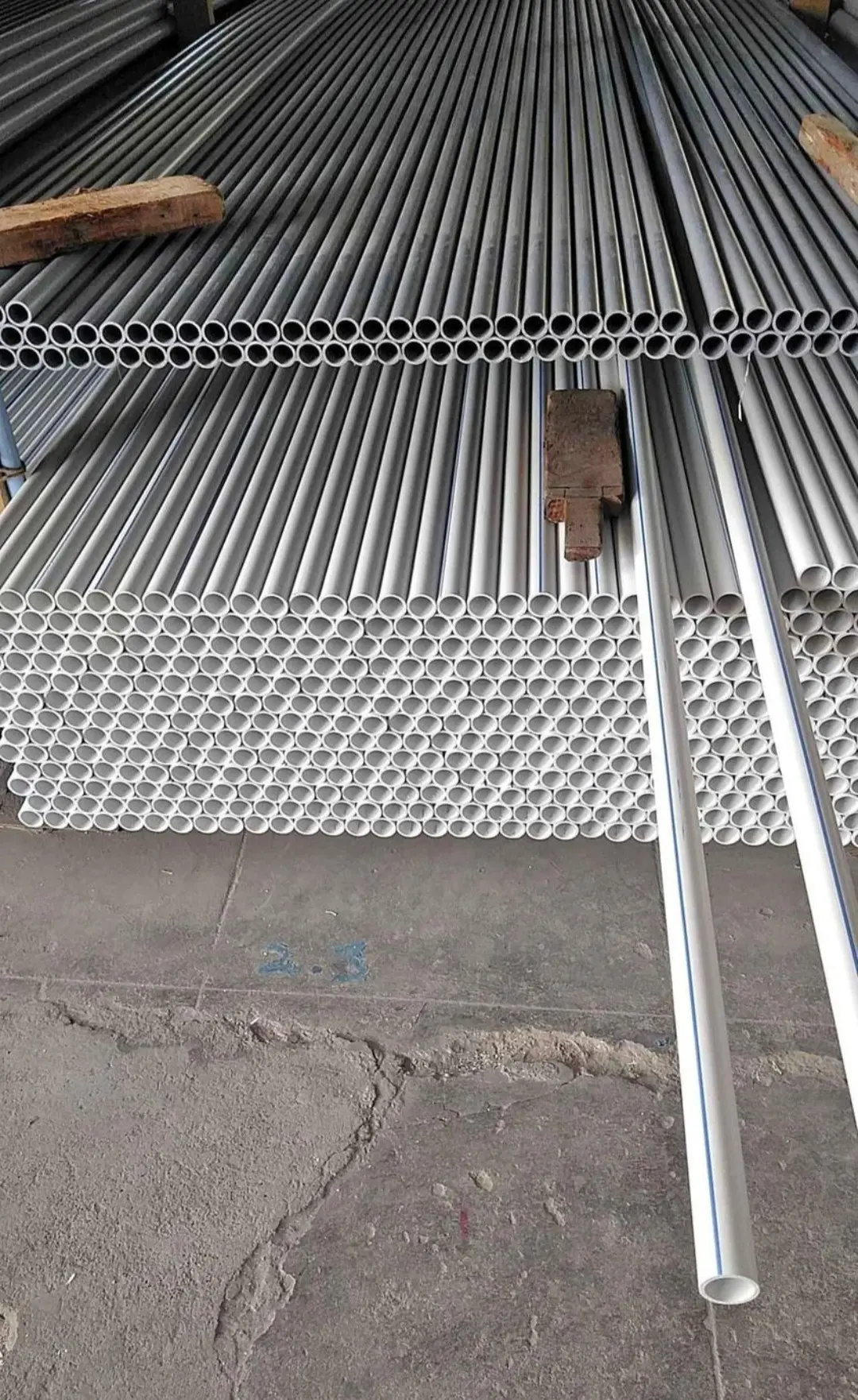 Warehouse stacks, grey + white PVC pipes
